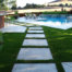 Stone tile on medium grass, with stone tile patio and pool deck