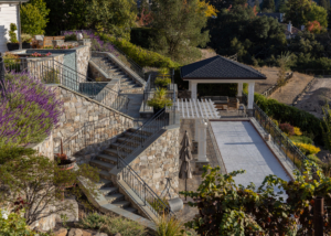 Hillside view from vineyard of complex terraces and staircases leading from upper patio to lower bocce terrace