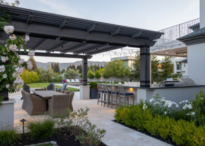 Entry path to outdoor living areas flanked by planting, showing structure of pergola and rooftop deck