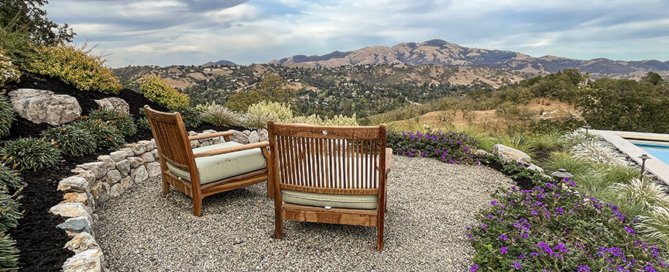 Gravel path opens out into seating area at overlook