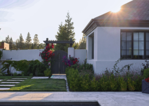 Custom gate, trellis, and privacy wall enhanced with gorgeous jewel-tone plantings