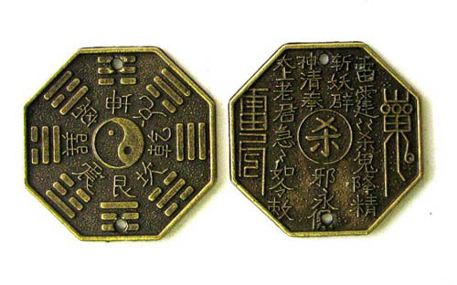 Traditional Feng Shui coins featuring yin-yang symbol and Chinese characters for harmony and protection.