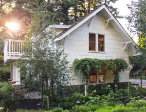 Traditional house with lush spring landscape in shades of green