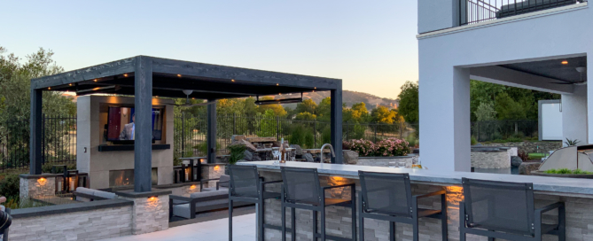 Elegant custom pergola with entertainment center and fireplace and lounges as seen from bar