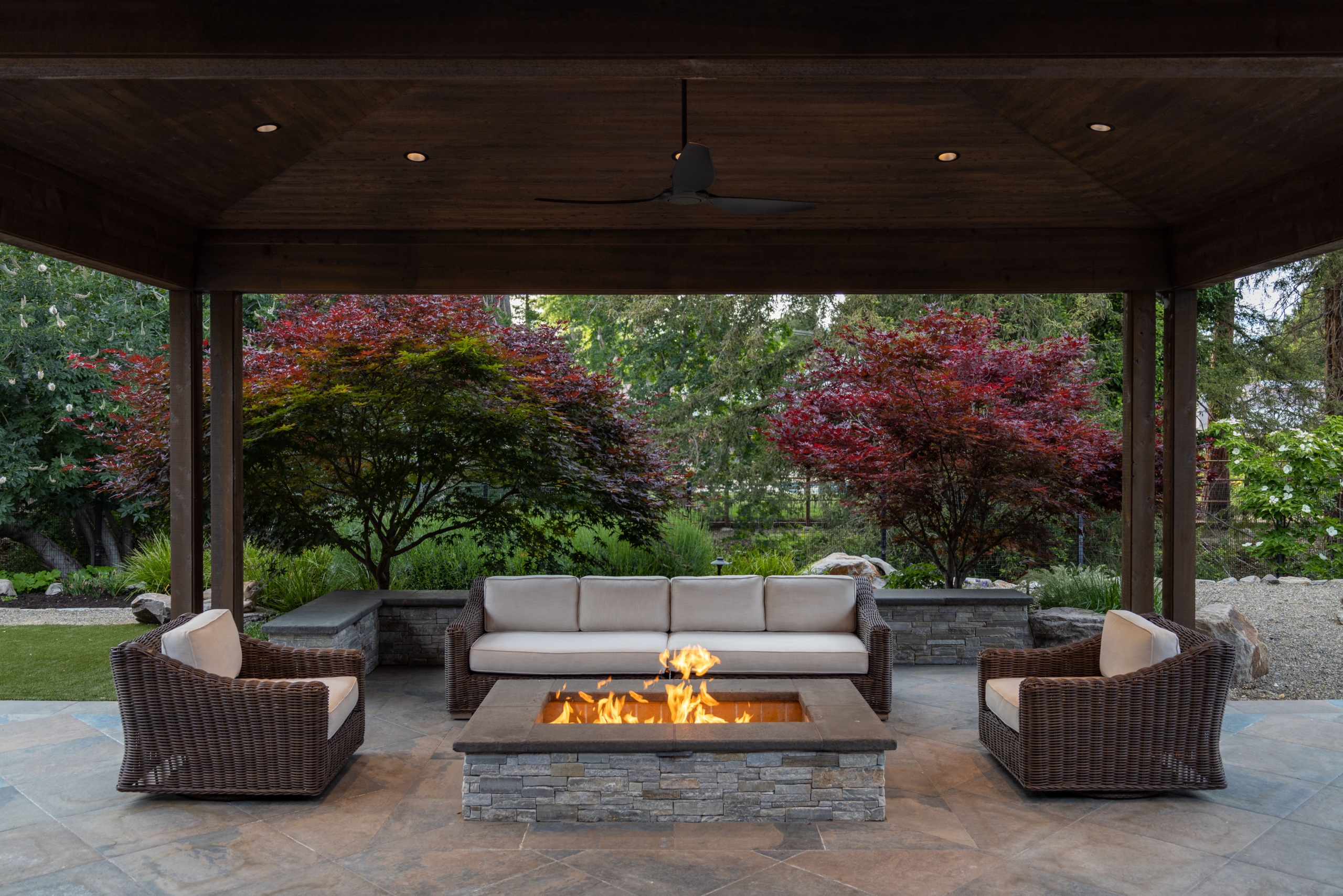 Contemporary outdoor fireplace in stone with wood detailing