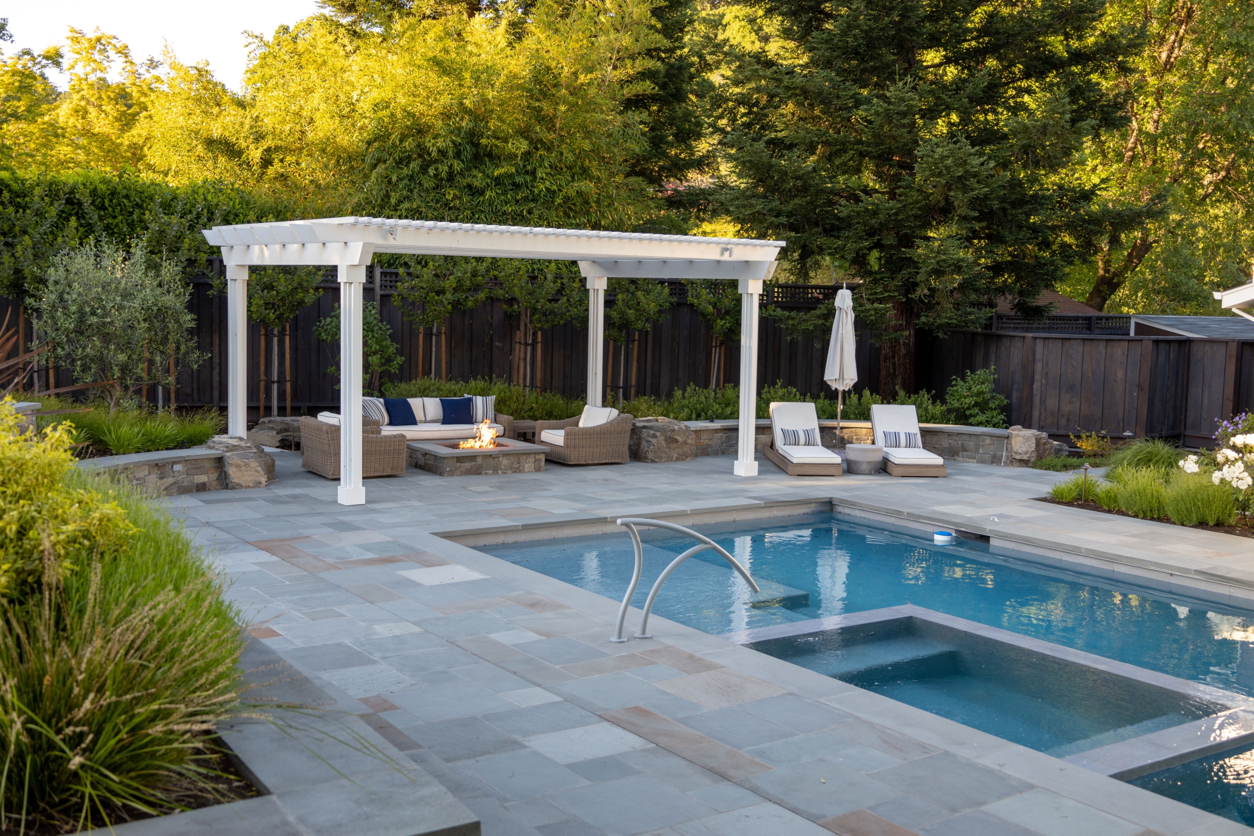 Contemporary curvilinear stone steps with tile patio and ambient lighting
