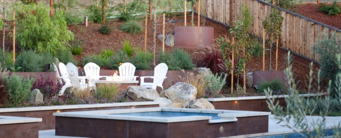 Luxury Bay Area residential landscape architecture featuring custom Corten steel planters and terraced retaining walls, integrated seating, and layered, contemporary planting design.